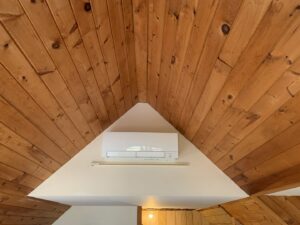 A ductless mini-split indoor unit installed on a wall by Atmos HVAC in Quincy, MA.