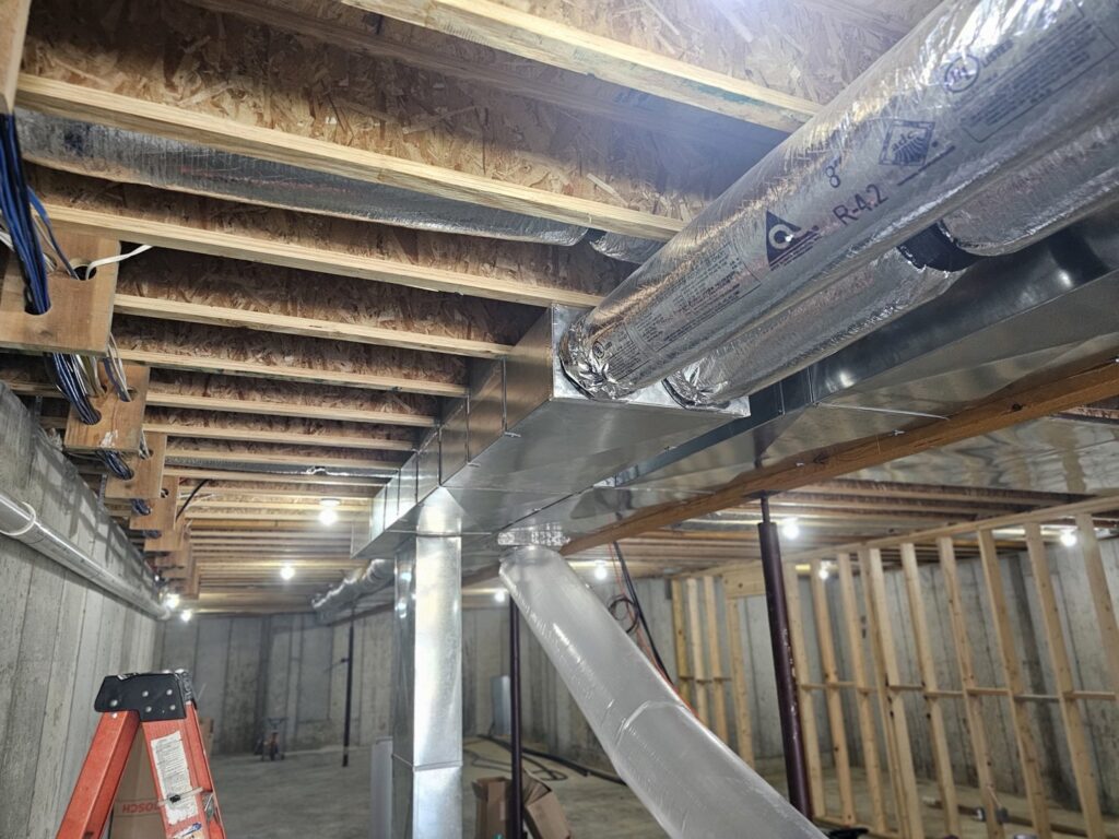 Extensive ductwork installation in an unfinished basement by Aces of Air Inc. in Georgetown, KY.