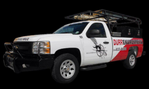 A white Durr Environmental Services pest control truck with a ladder rack and toolboxes, ready for service in Baton Rouge, LA.