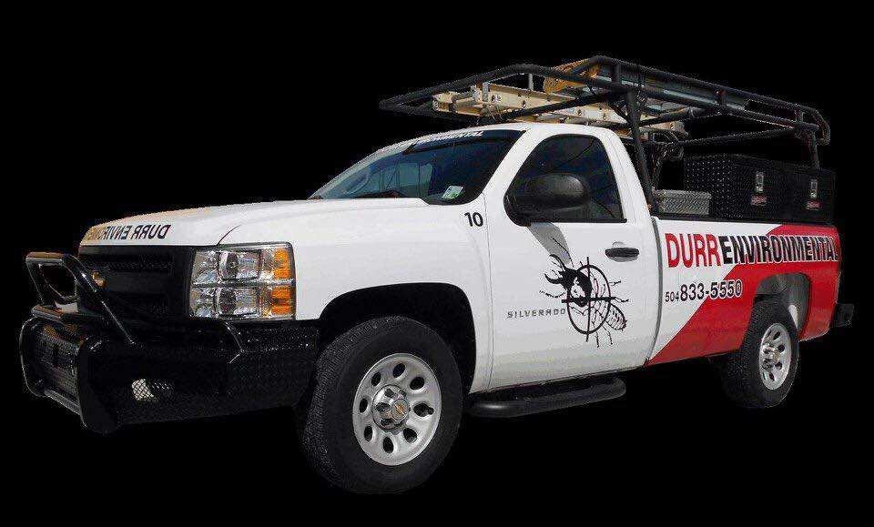 A white Durr Environmental Services pest control truck with a ladder rack and toolboxes, ready for service in Baton Rouge, LA.