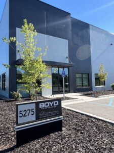 The modern exterior of Eastpointe Interiors business location in Caledonia, MI, with a sign indicating "Your Flooring Solution Provider".
