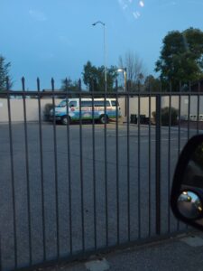 A Lady Bug ECO FRIENDLY Pest Control Eco-Heat van parked behind a fence, indicating bed bug services in Mesa, AZ.