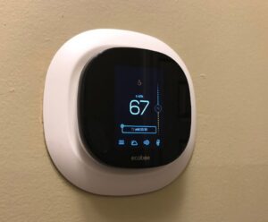 An Ecobee smart thermostat installed on a wall, a service offered by U.S. HVAC Services in Madison, AL.