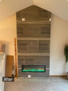 An electric fireplace installation in progress, showing the cement board and insert, by Spartan Heating, Cooling and Fireplaces in Cedar Rapids, IA