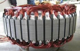 A close-up view of an electric motor stator with newly installed copper windings, demonstrating electrical expertise by Alexco Max Electricals And Construction in Madina, GH.