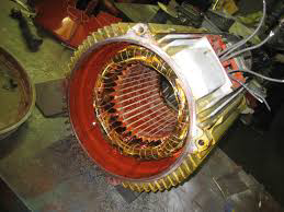 Close-up of an electric motor stator with new copper windings, showcasing electrical repair work by Alexco Max Electricals And Construction in Madina, GH.