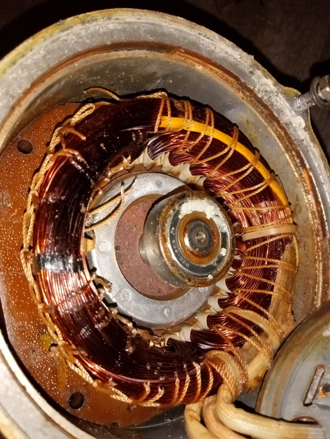 Close-up of electric motor stator windings being repaired by All Seasons Electric Motor and Small Engine Repair in Fayetteville, NC.