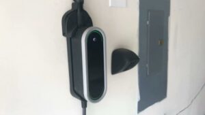 An electric vehicle charger and electrical panel installed in a garage by Royal Electric Services in Raleigh, NC