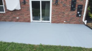 An electric vehicle charging station installed on an exterior stone wall by Gurley Electric LLC in Churchville, MD