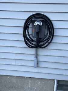 An electric vehicle (EV) charger professionally installed on a home by Russell Electric LLC in Saint Clair, MI