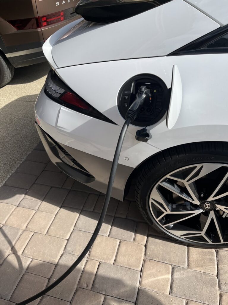 An electric vehicle charging at a residential charging station installed by HomeRun Electric LLC in Arlington, TX