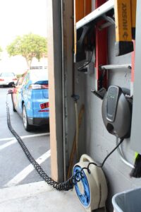 An electric vehicle charging station installed by WireMasters Electric, Inc. in Miami, FL, with a car charging.