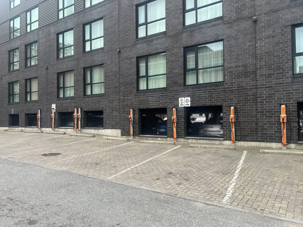 Multiple electric vehicle charging stations installed outside a building by Cummings Electric in South Burlington, VT