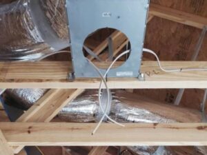 An electrical box with wiring in an attic, demonstrating rough-in work by Decatur Electrician Now in Decatur, AL.