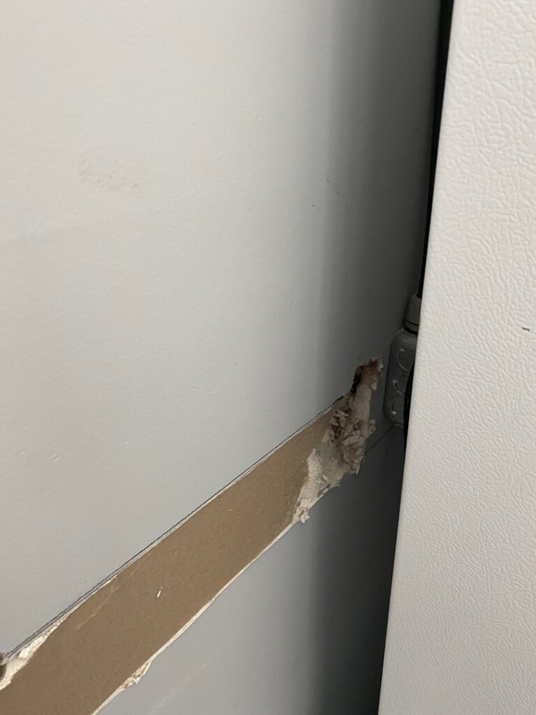 A close-up of an electrical box and conduit exposed in a wall during an installation by LANG ELECTRIC in Knoxville, TN.