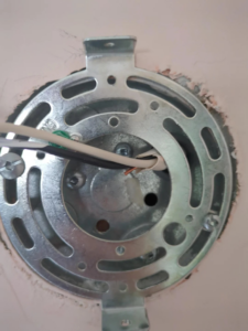 An electrical box mounting bracket with wiring being installed by Ask Electricians in Los Angeles, CA.