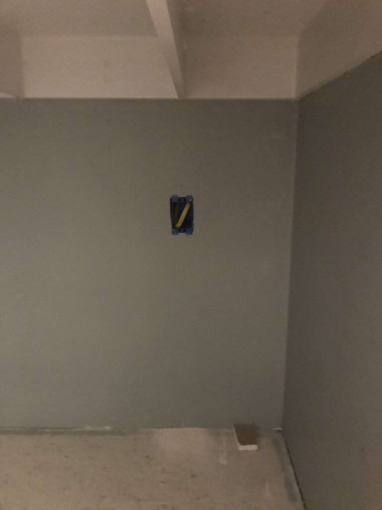 An electrical box cutout with wires during rough-in work by Christensen Electric in Galveston, TX.