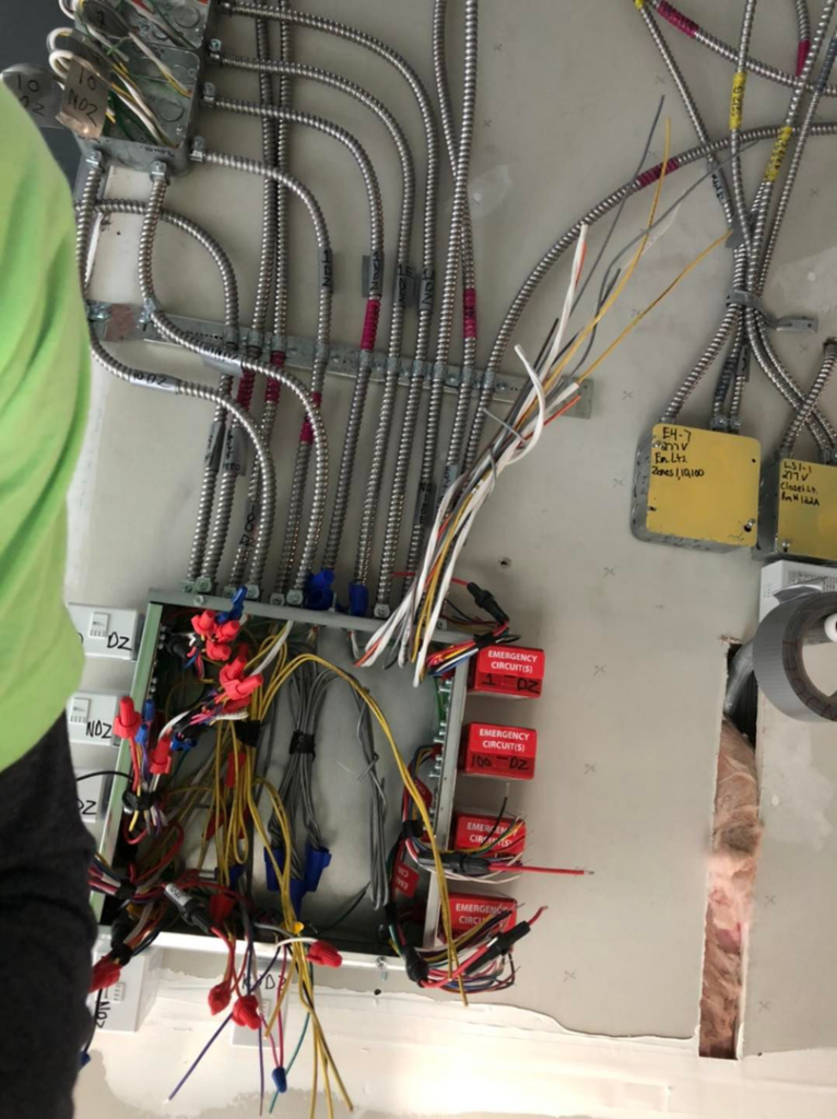 Electrician performing wiring installation in an electrical box for Steve Thomson Electric in Fort Worth, TX.