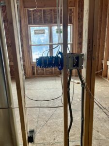 Electrical boxes and conduit installed within a framed wall during construction by P.H. Electric in Soulsbyville, CA.
