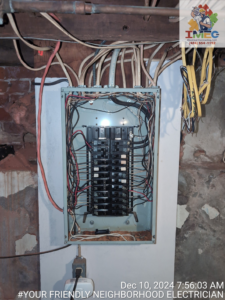 An electrical breaker box with exposed wiring during an installation or repair by Imecpower in Bethlehem, PA.
