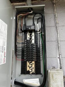 An electrical breaker panel showing wiring and components serviced by Dynamic Electric in Cape Coral, FL.