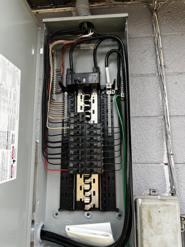 An electrical breaker panel showing wiring and components serviced by Dynamic Electric in Cape Coral, FL.