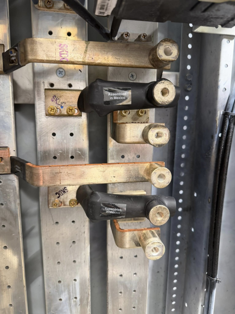 Close-up of electrical bus bars and connections inside a panel by Power Tech Electrical Services in Durham, NC.