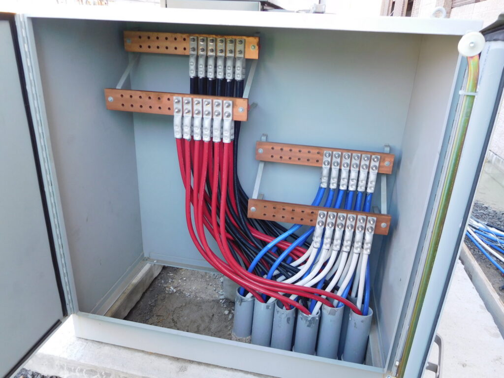 Close-up of electrical busbar connections with colored wires installed by Bonham Electric, Inc. in Sacramento, CA.