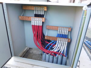 Close-up of electrical busbar connections with colored wires installed by Bonham Electric, Inc. in Sacramento, CA.