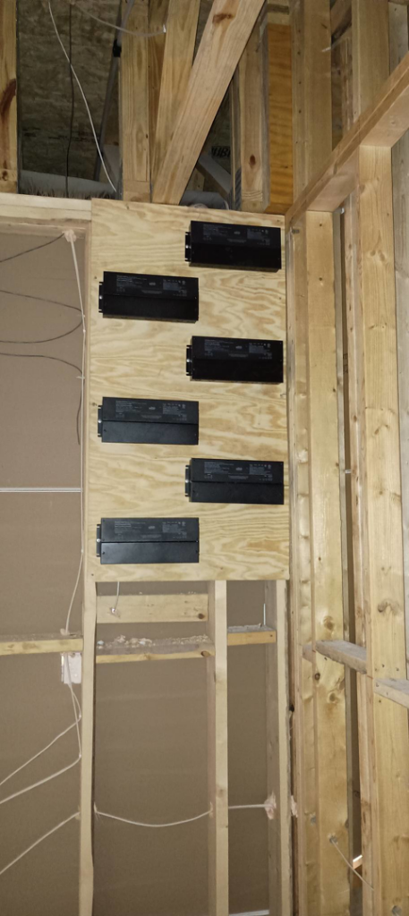 Essential Electric LLC installing electrical components on a plywood board during a job in Lancaster, KY.
