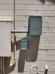 Electrical conduit and junction boxes installed on a brick wall by CDB Electrical LLC in Tucson, AZ.