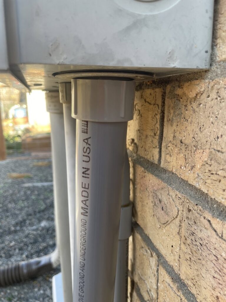 Close-up of electrical conduit installed on a brick wall by Wilson Electrical Contractors in Orlando, FL.