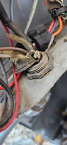 A close-up view of electrical conduit entering an HVAC unit, serviced by Anubis Mechanical in Goose Creek, SC.