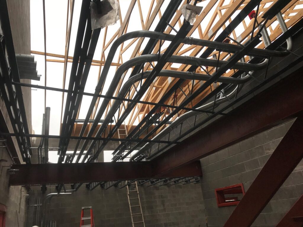 Electrical conduits installed along the ceiling structure of a commercial building by Babcon Electric Inc. in Richmond, KY