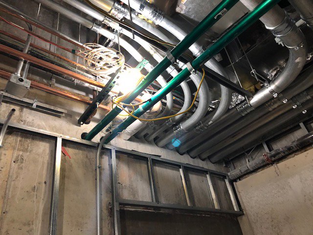 Close-up of electrical conduit installation on a ceiling at a job site by RD Graham Electric, LLC in Greensboro, NC.