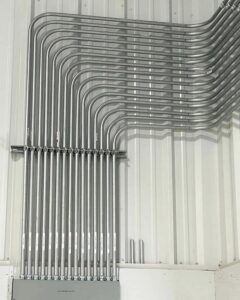 Neatly installed electrical conduits on a wall, showcasing professional work by Next Level Pros in Lakewood, CO.
