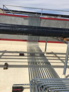 Rooftop installation of multiple electrical conduits by New Revelation Technologies LLC in Nampa, ID.