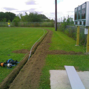 An electrical conduit being installed in a trench by Southern Electrical Services in Houma, LA