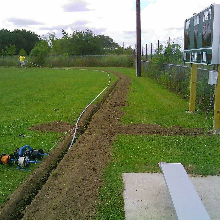 An electrical conduit being installed in a trench by Southern Electrical Services in Houma, LA