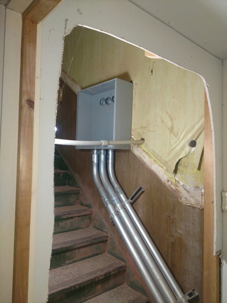 Electrical conduits installed along a staircase in a building by Icon West Corporation Electrical Contractors in Springfield, MA.