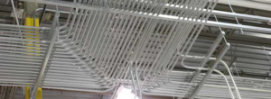 Complex electrical conduit installation on a ceiling by Stephens Electric in Springfield, MA.