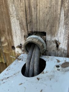 A close-up of an electrical conduit entry point into a service box, installed by York Electric of Westchester in Yonkers, NY.