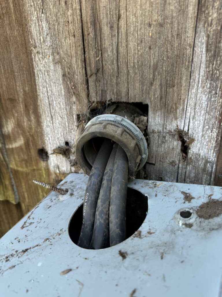 A close-up of an electrical conduit entry point into a service box, installed by York Electric of Westchester in Yonkers, NY.