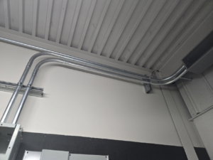 Electrical conduit installation running along a wall and ceiling by ZJW Electric LLC in West Hartford, CT