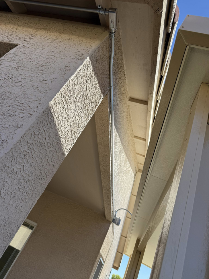 Electrical conduit and junction box installed on an exterior wall by Dependable Sparky Electric in Peoria, AZ