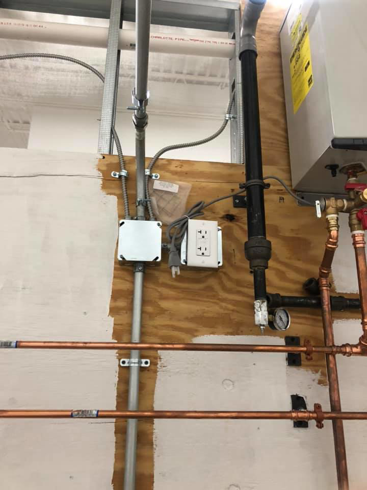 Electrical conduits and outlets installed next to plumbing by Jon Chamberlain Electrical Services in Saxton, PA.