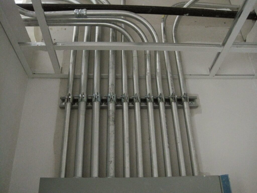 Neatly installed electrical conduits running into a panel or junction box by Argosy Electric, Inc. in Newport News, VA