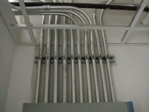 Neatly installed electrical conduits running into a panel or junction box by Argosy Electric, Inc. in Newport News, VA