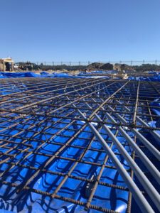 Electrical conduit laid out with rebar on a construction site, part of a project by Harbour Electric in Wilmington, NC.