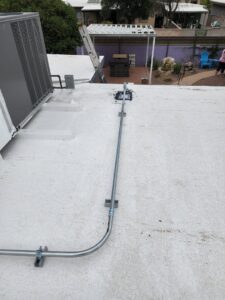 Electrical conduit installed across a white commercial roof by CDB Electrical LLC in Tucson, AZ.